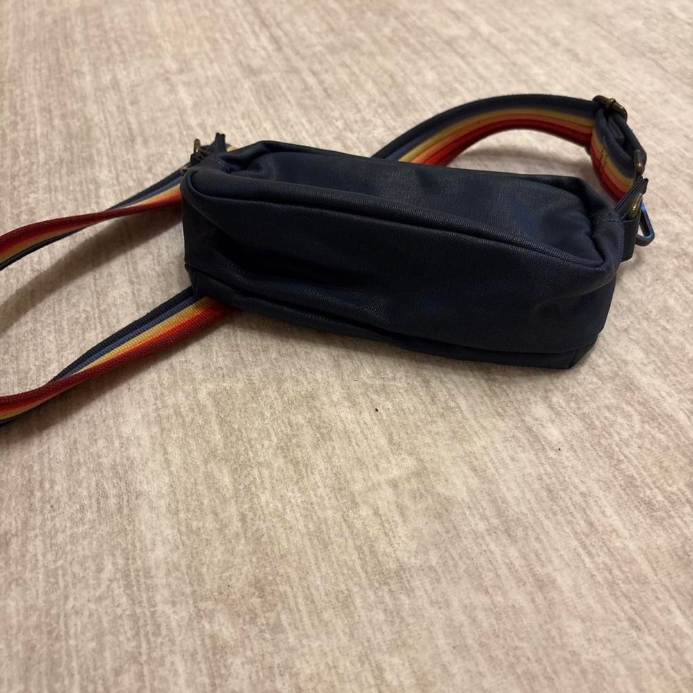 Marine Layer navy blue crossbody bag with rainbow striped strap
